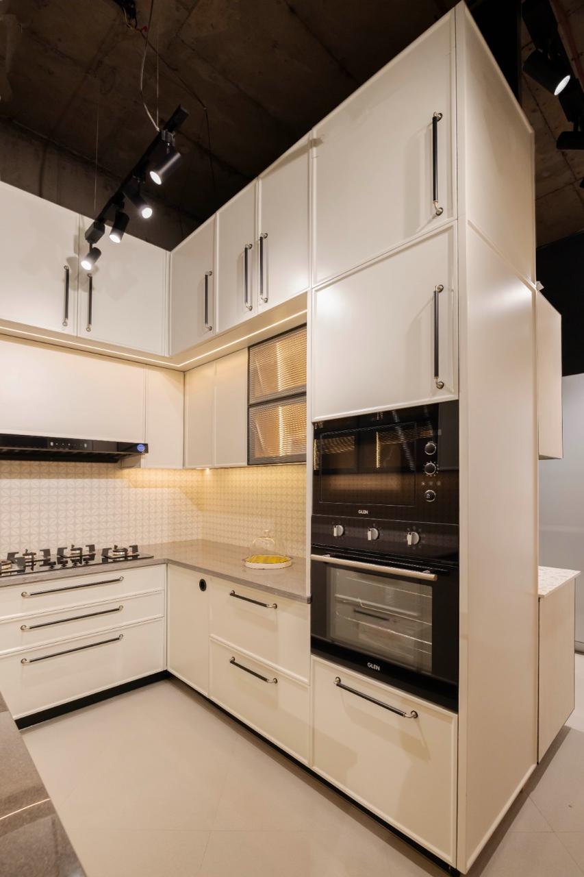 Ddesignery modular kitchen showroom in Gurgaon – L-shaped kitchen with premium laminates